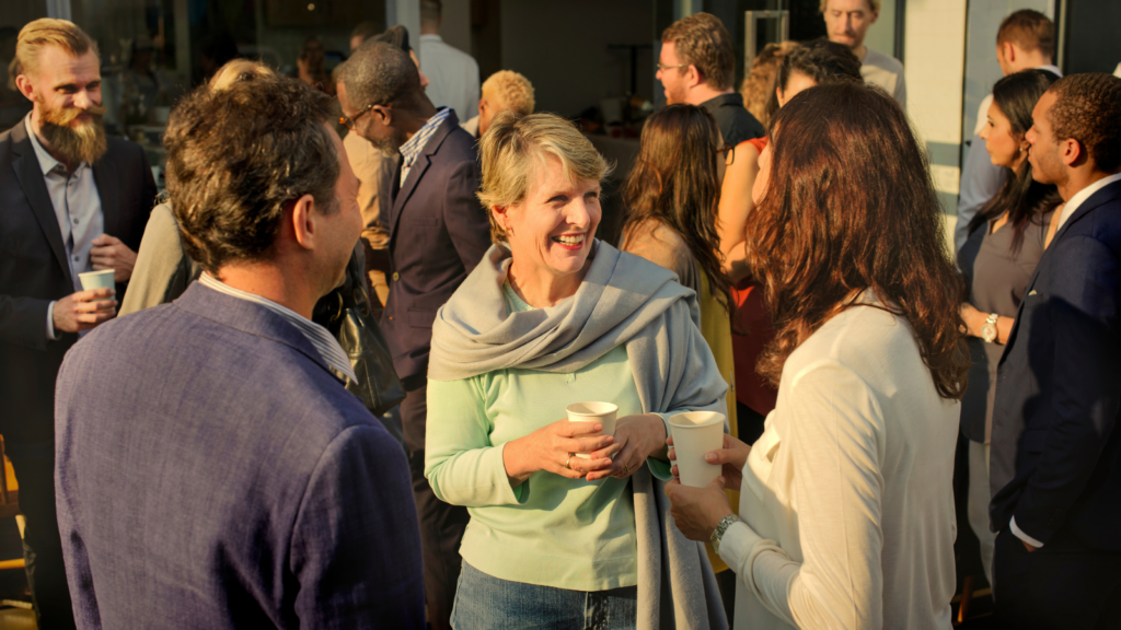 Professionals talking and mingling at an outdoor business event